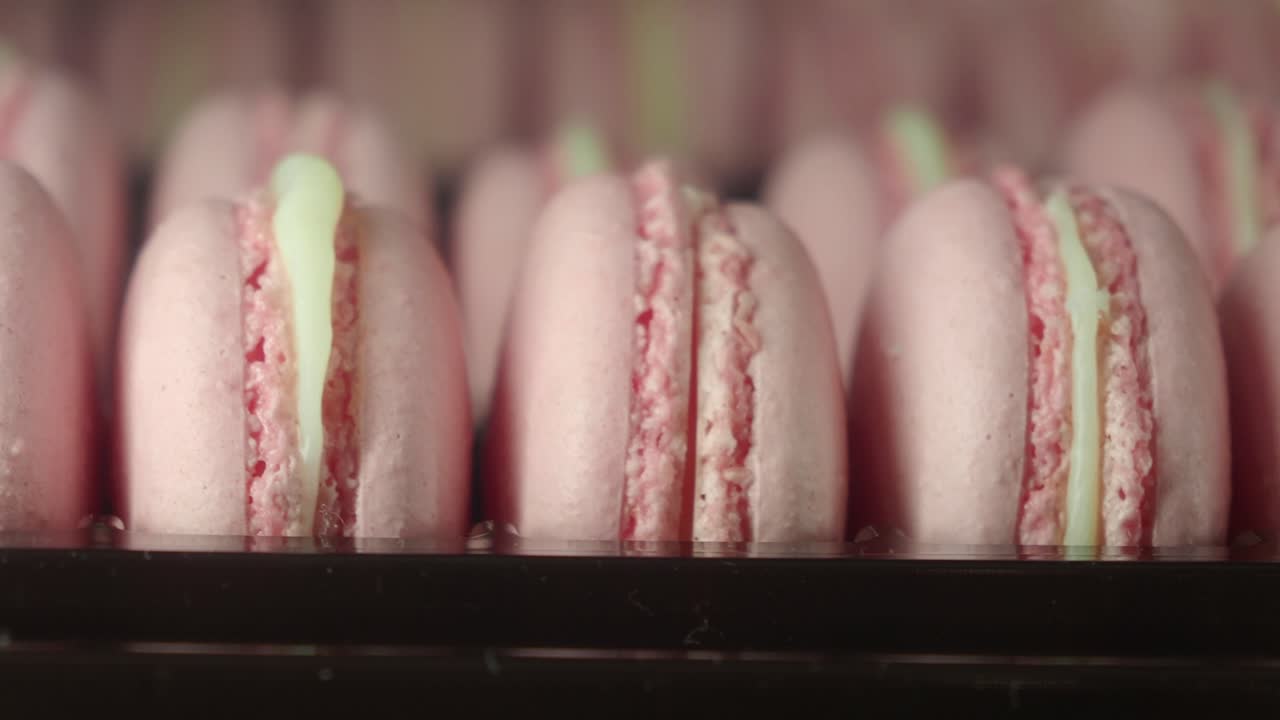 Close-up View of Delicious Pink Macarons with Cream Filling