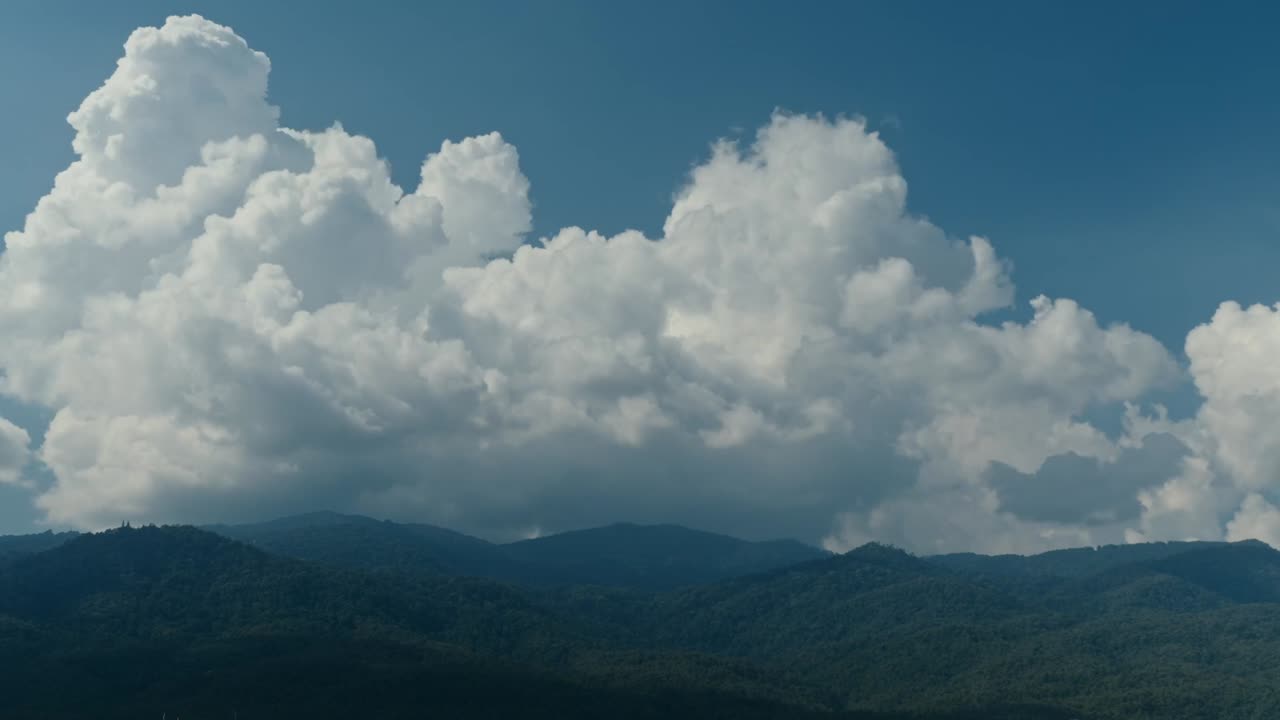 Mountain Range with Cumulus Clouds