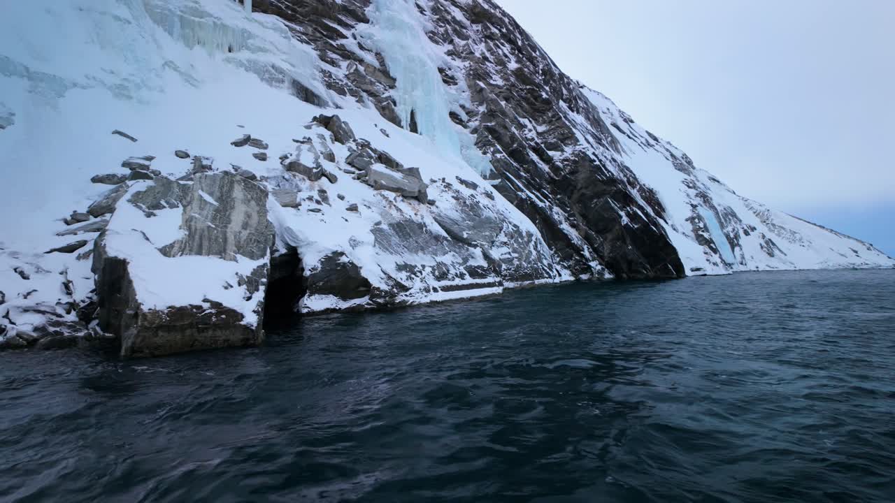 Icy coastal cliffs by the sea near Nuuk on Greenland's southwest coast
