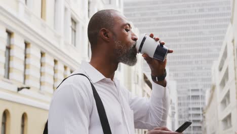african american man drinking a coffee in the sreet