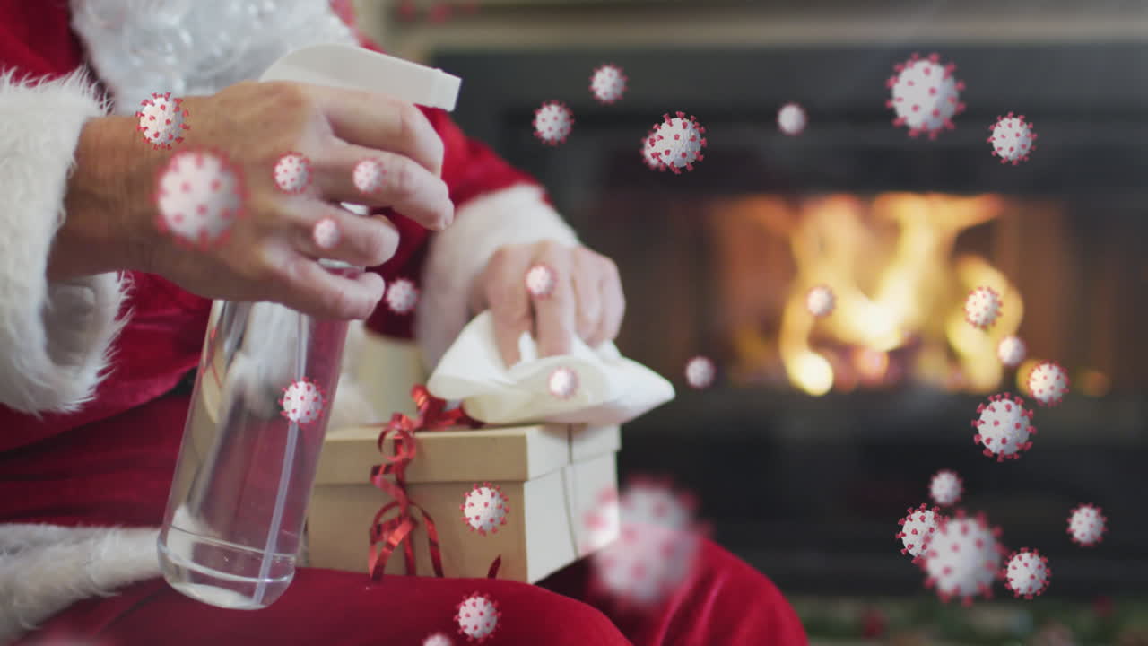 animación de las células de covid 19 sobre el presente de las toallitas de santa claus