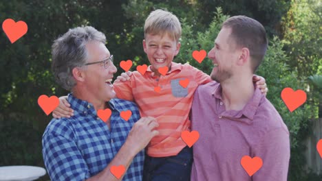 Animation-of-hearts-over-happy-caucasian-three-generation-men-hugging-in-garden
