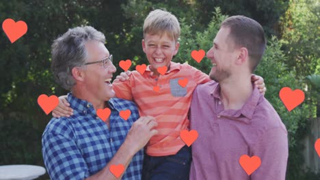 animation of hearts over happy caucasian three generation men hugging in garden