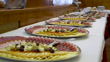 a beautifully served banquet table with various snacks and appetizers at a wedding celebration