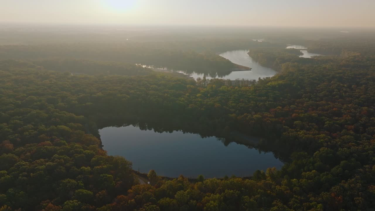 Serene aerial view of lakes and forests at dawn in fall, calm and peaceful
