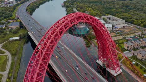 aerial flies above the red highway bridge with traffic, moscow, russia