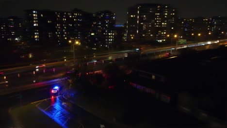 police and ambulance with emergency lights at night cityscape, aerial view