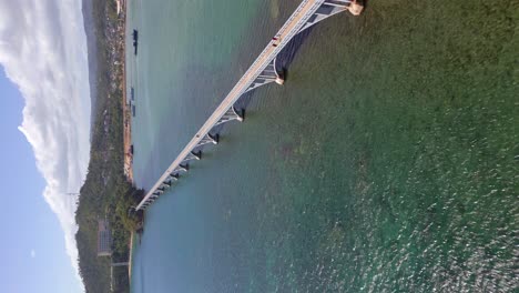 People-Walking-On-The-Bridge-Connecting-The-Islands-In-Samana-Bay,-Dominican-Republic