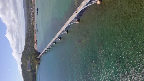 people walking on the bridge connecting the islands in samana bay, dominican republic