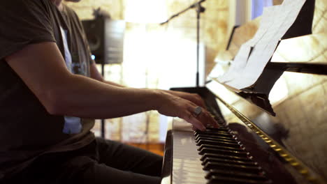 side view of greek caucasian male, playing a classic vintage piano at home 4k