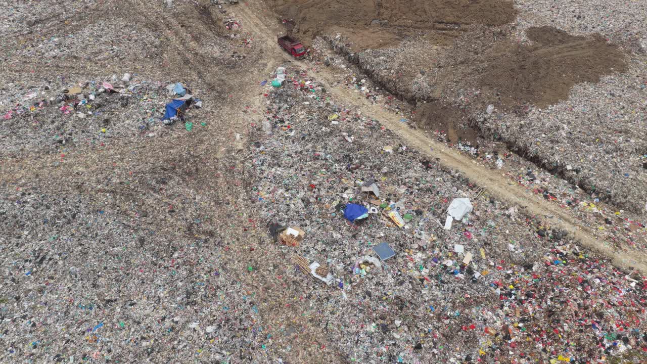Aerial view of garbage trucks at a large landfill