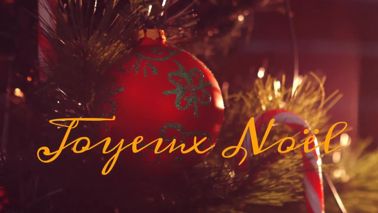 Animazione del testo "joyeux noël" su decorazioni natalizie.