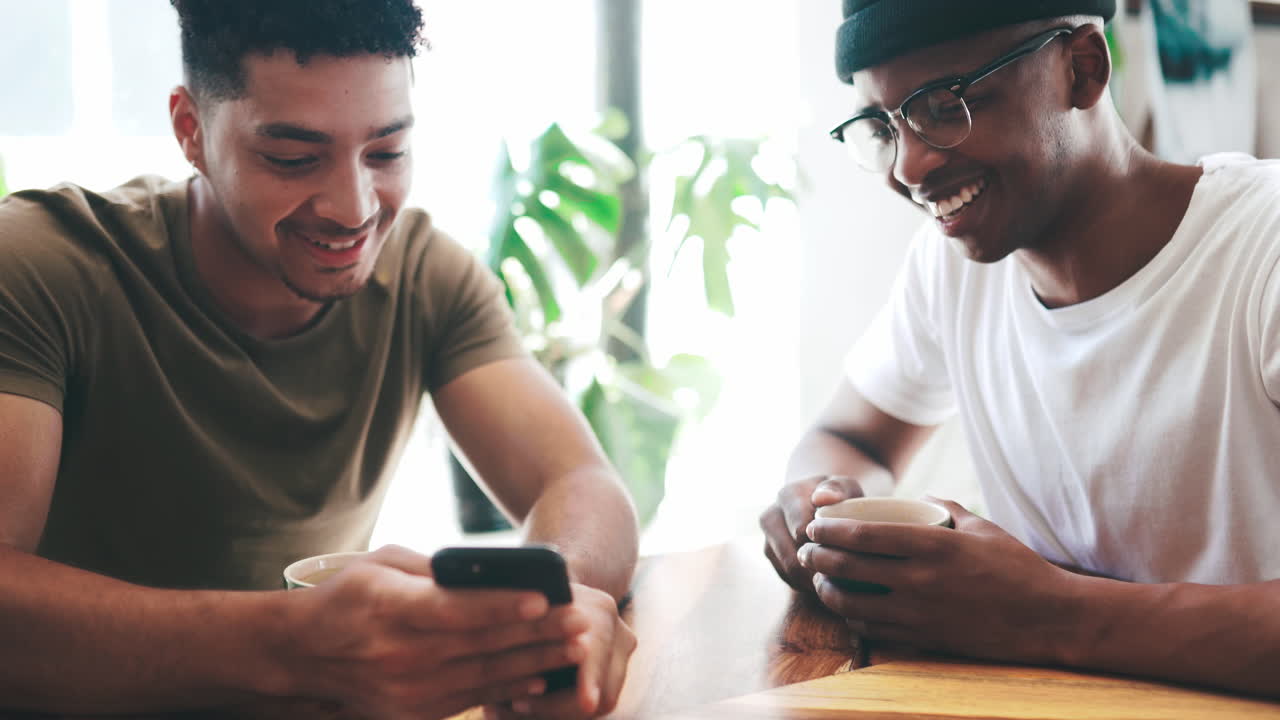 two young men chatting over coffee in a coffee