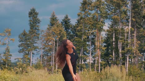 energetic carefree young caucasian woman twirling in forest, slow motion