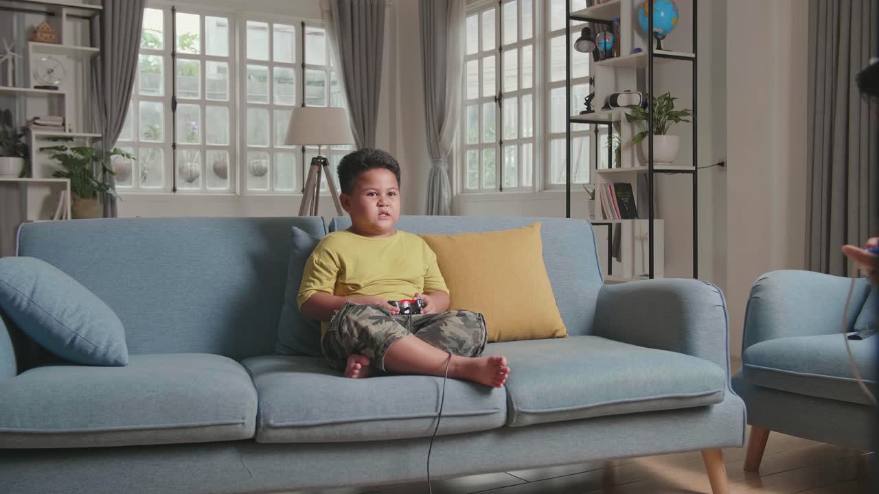 Little Boy'S Hand Using Joystick While Playing Game At Home