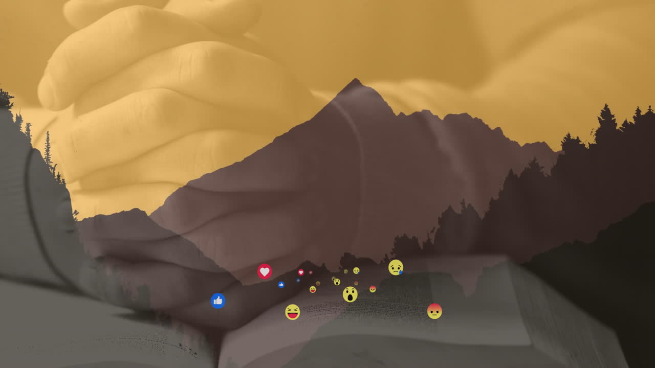 Holding book with mountain silhouette and animation of social media icons