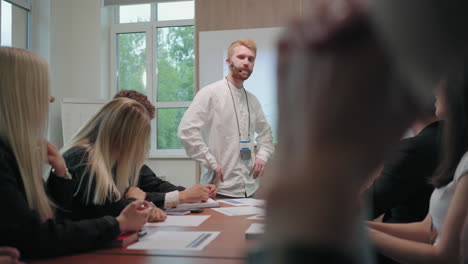 confident man is speaking in business meeting colleagues and partners are applauding him