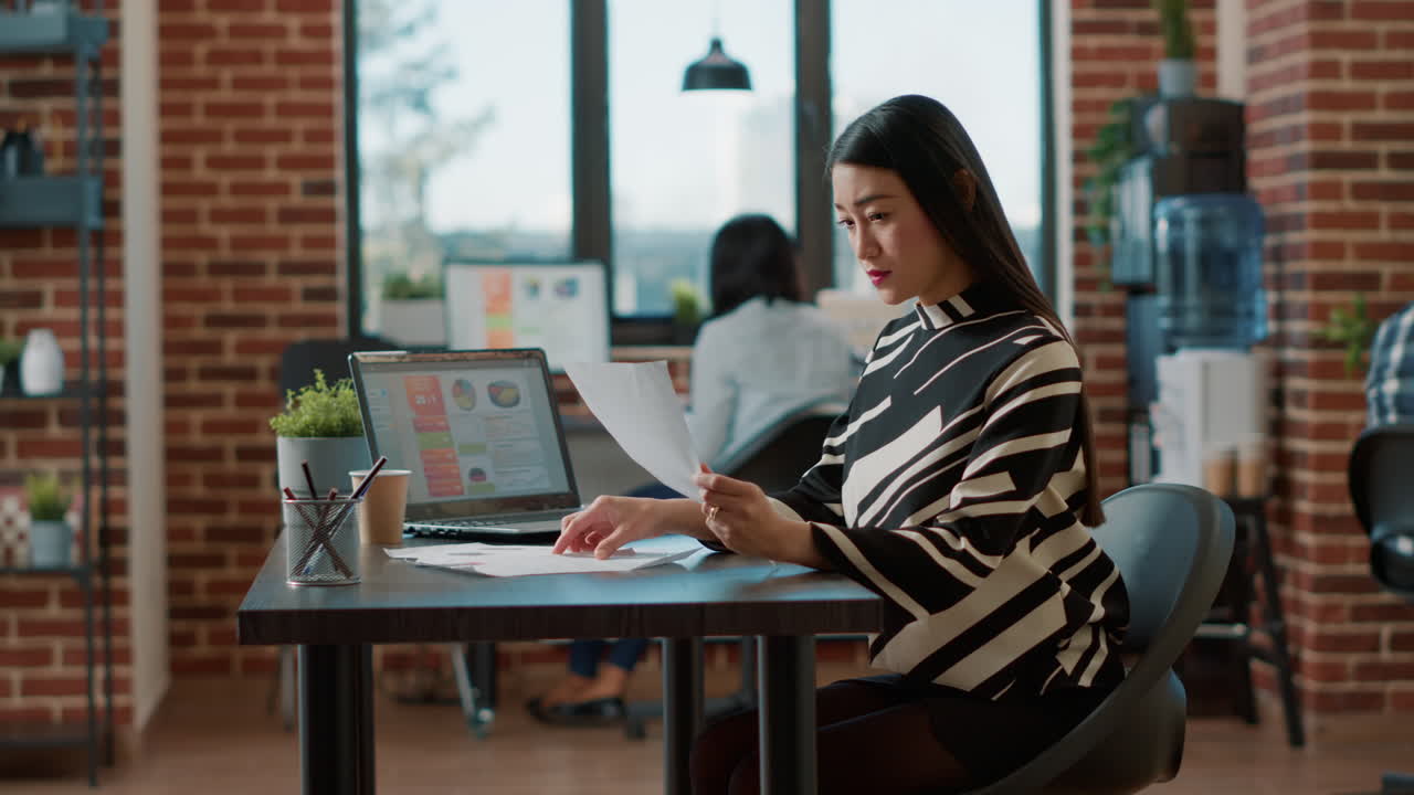 Portrait of asian HR employee analyzing cv information of candidates