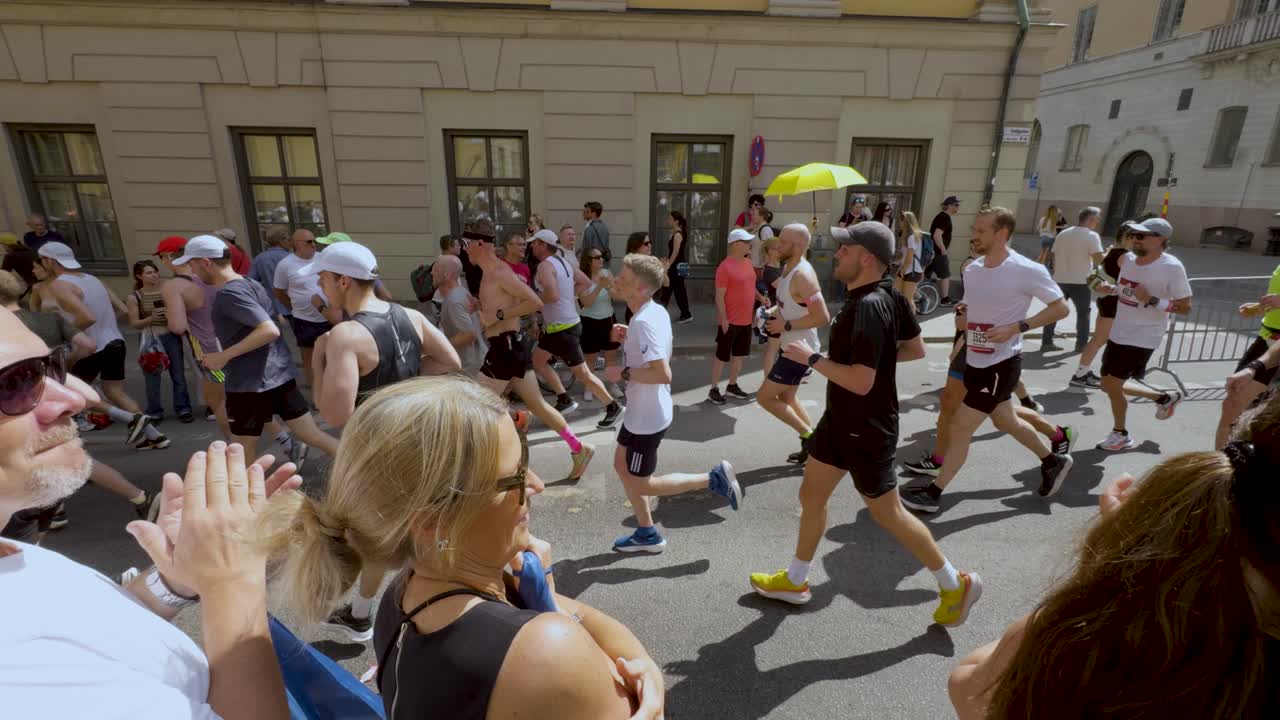Spectators Applauding Runners On Street At Stockholm Marathon Event In Sweden. slow motion