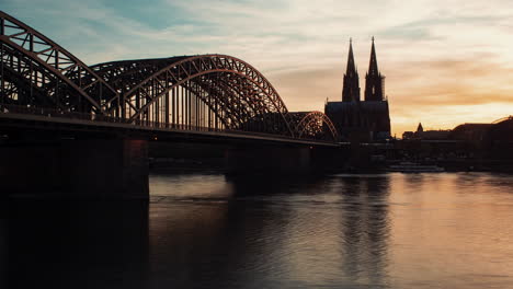 sunset over cologne cathedral and hohenzollern bridge