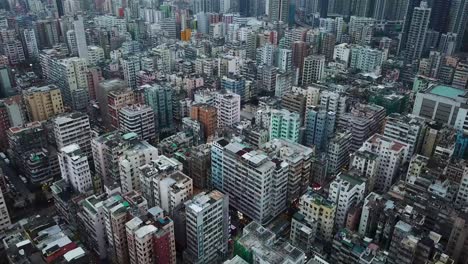aerial view closing in on mass buildings in sham shui po, one of the poorest district of hong kong.