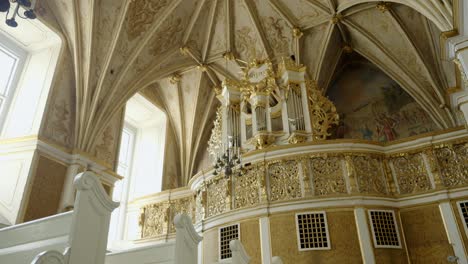 ornate church organ in a vaulted ceiling