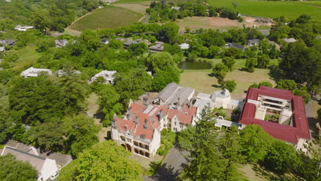 Aerial-ascending-footage-of-buildings-in-park.-Large-residencies-in-city-suburbs.-Cape-Town,-South-Africa