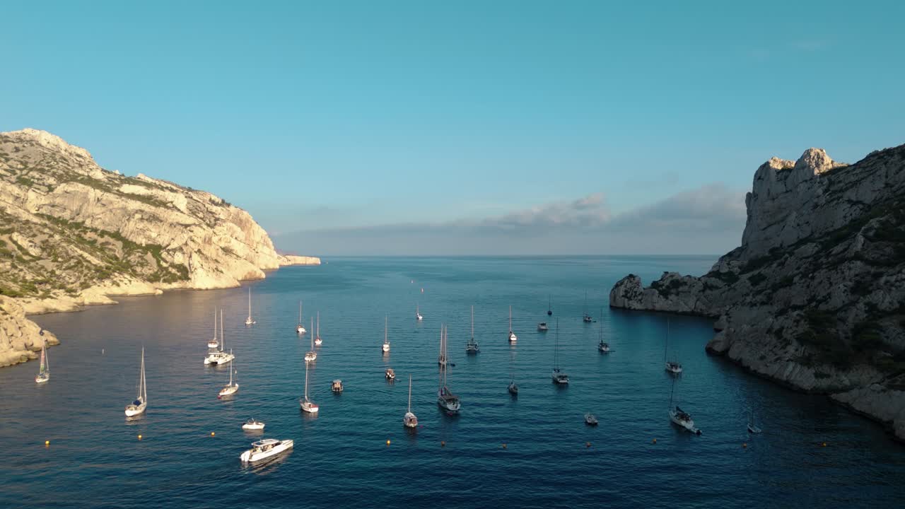Aerial revealing shot of sailboats anchored in the Nice bay during summer