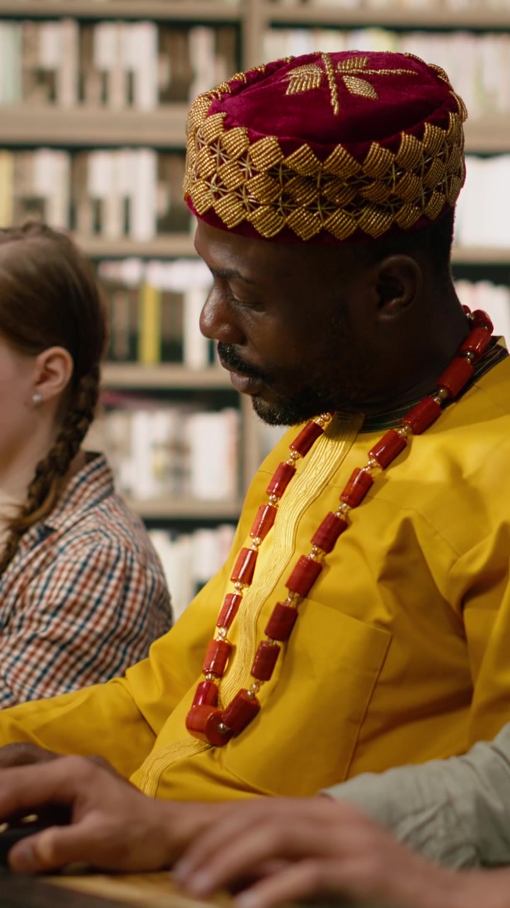 Vertical Video Adult Student In Traditional Yellow Clothing Works At Desktop Computer