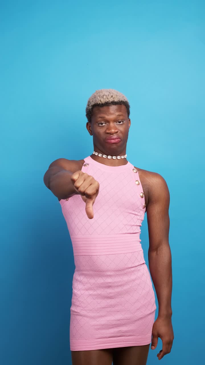 Displeased black gay man gesturing thumb down