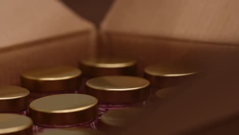 brown box filled with bottles closed by hand - getting ready for delivery