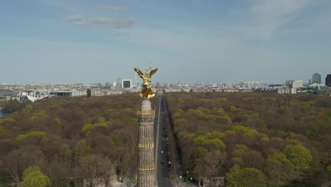 AERIAL:-Close-Up-Dolly-of-Berlin-Victory-Column-Golden-Statue-Victoria-in-Beautiful-Sunlight-and-Berlin,-Germany-Cityscape-Skyline-in-Background