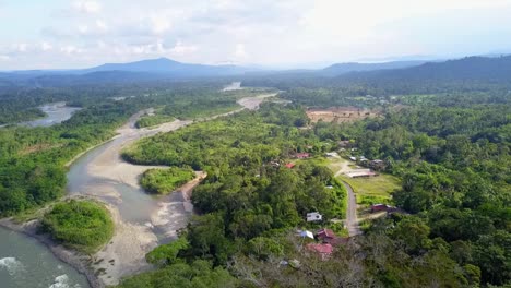 river flowing through vivid landscape with mountain range in background