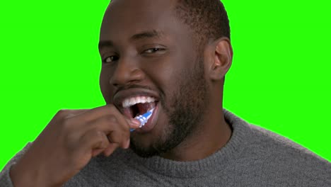 dark-skinned man brushing his teeth.