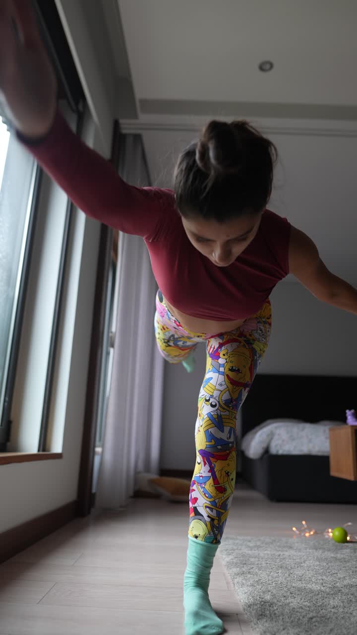 Woman doing a leg balance exercise at home