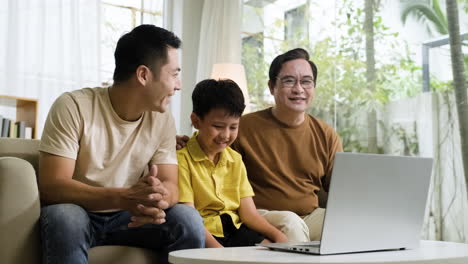 asian men and boy in the living room