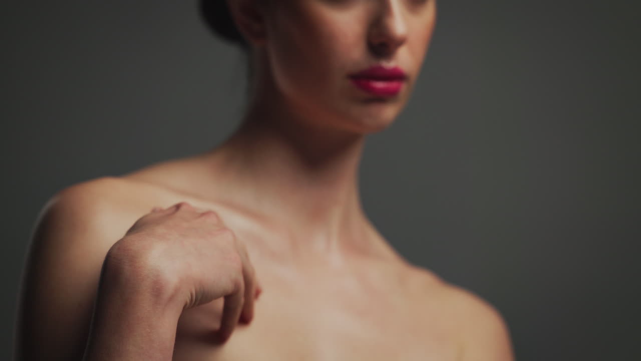 A woman with red lipstick and smooth skin