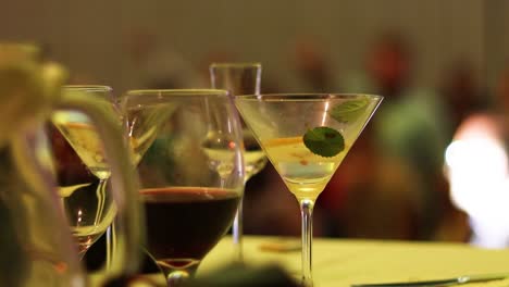 cocktail drinks at wedding ceremony party, people dancing in background, close up