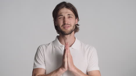 caucasian man in front of camera on gray background.