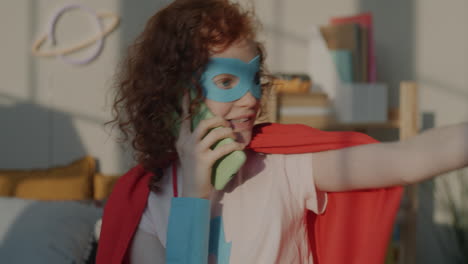child superhero talking on phone
