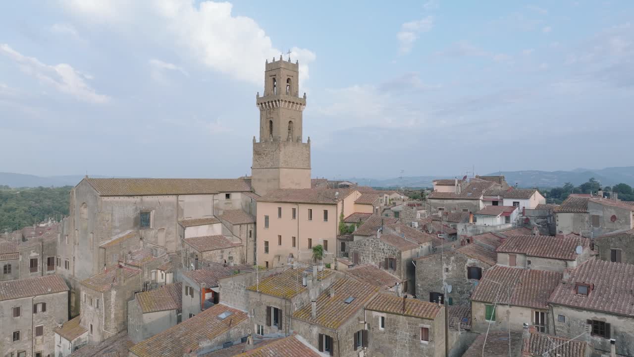 Aerial Drone view of the hilltop Medieval town of Pitigliano, Tuscany in morning light, flying over old buildings and rooftops, in 4K