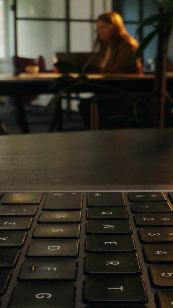 Closeup of hands typing on a laptop keyboard