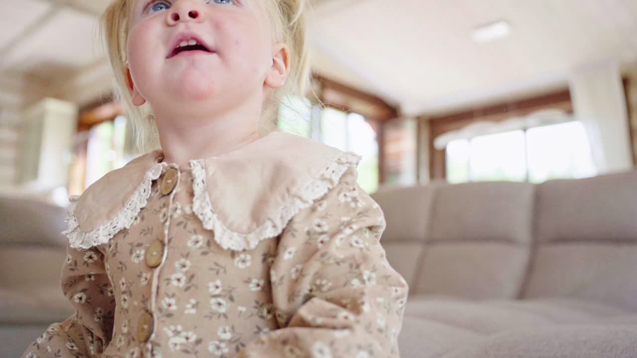 Toddler girl playing in a living room