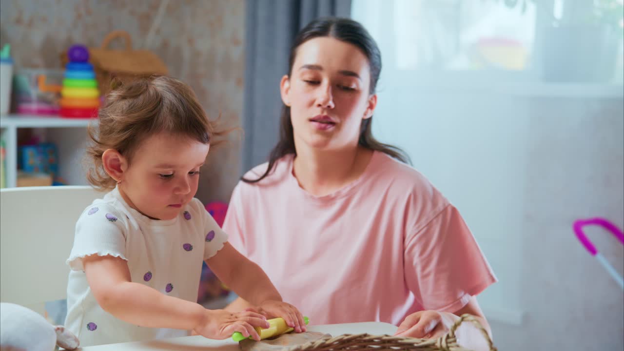 A Heartwarming Moment of Creative Playtime: A Little Girl Engaged in Crafting with Her Caring Adult in a Bright and Inviting Room Full of Colorful Toys