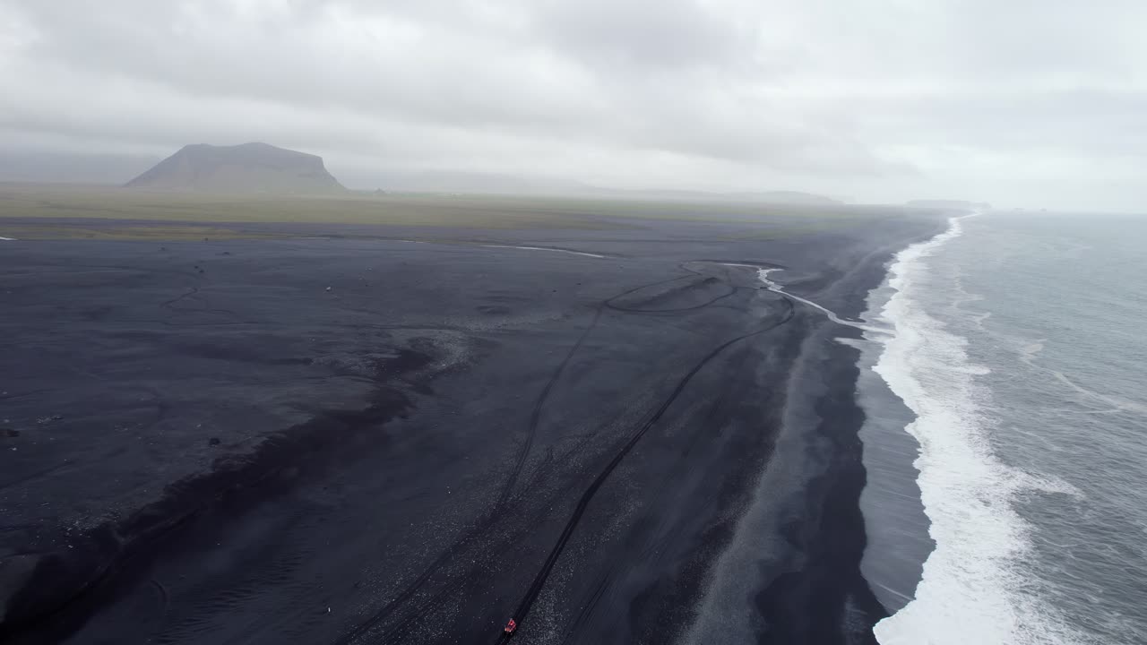 Flying along Iceland's endless black sand beach in Solheimfjara