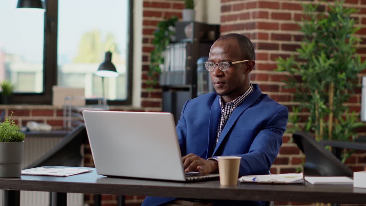 Happy businessman celebrating project success in startup office