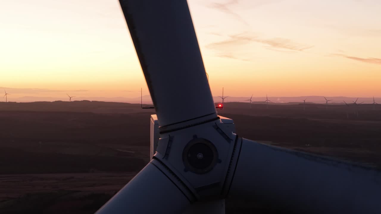 Blades And Hub Of A Wind Turbine At Sunrise - Converting Kinetic Energy Of Wind Into Electricity. - aerial shot