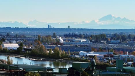 mountain range seen across industrial area in vancouver, british columbia, canada