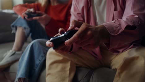 couple playing video games on couch