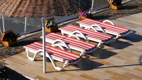 empty sunbeds near the hotel and the beach. morning on a beach, beach with sun loungers and sun umbrellas.